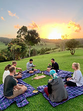 Rolling Hills Retreat participants enjoying nutritious food at sunset, part of a holistic wellness retreat experience
