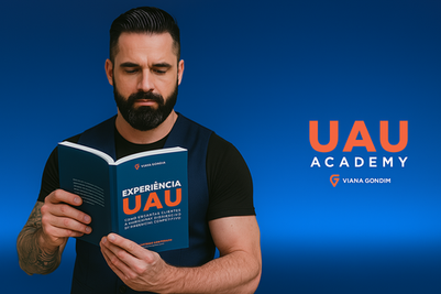 Homem musculoso de colete lendo o livro Experiência UAU com fundo azul escrito UAU Academy.