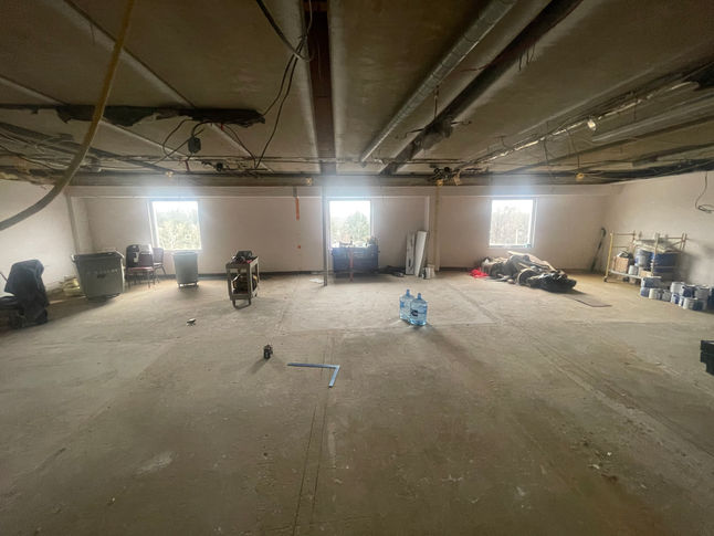 Picture of a stripped interior space at a pediatrician facility during the renovation process done by PRM services.