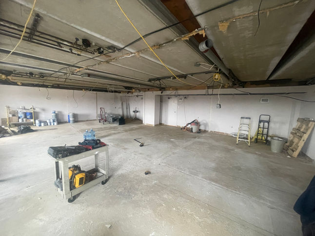 Picture of a stripped interior space at a pediatrician facility during the renovation process done by PRM services.