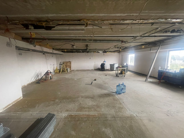 Picture of a stripped interior space at a pediatrician facility during the renovation process done by PRM services.