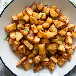 Crispy hashbrowns made from golden cubed russet potatoes, fried to perfection and served with ketchup – a flavorful and satisfying breakfast side from Goodrich Gourmet Catering Company for business catering.