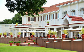 Popularly known as “the Grand Old Lady of the Falls”, the Victoria Falls Hotel is situated in the Victoria Falls National Park, a World Heritage site. A member of the exclusive Leading Hotels of the World group, this Edwardian-style hotel, built in 1904, has recently been refurbished to combine the charm of the old with the convenience of the new.
Set in lush tropical gardens with lily ponds, palm trees and semi-tropical shrubs, the hotel provides the tranquillity and seclusion that many guests seek. The famous Victoria Falls are within walking distance and “the smoke that thunders” or “Mosi-O-Tunya” in the local dialect, is audible and visible from this luxurious landmark. You might even feel a bit of spray as you walk in the gardens.
There’s a choice of restaurants and a bar, a swimming pool, a shop, a spacious lounge area and pretty gardens. The hotel can also help arrange several tours of the area. Of course, afternoon tea on the terrace is an essential part of any stay!
The rooms are all air-conditioned and have a television, safe, and tea and coffee-making facilities.