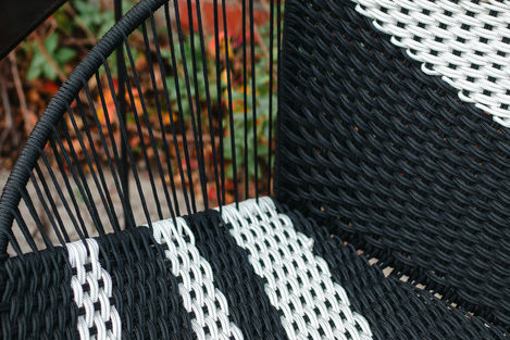 a black and white chair with a striped seat