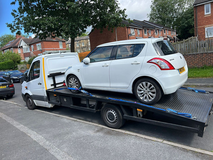 Recovery truck with white car on the back