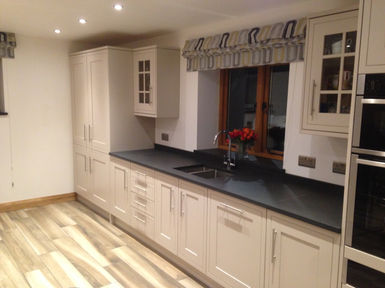 wooden flooring and new white kitchen