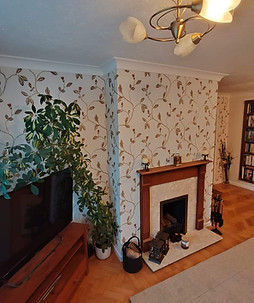 Wallpapering and painting a living area in a house
