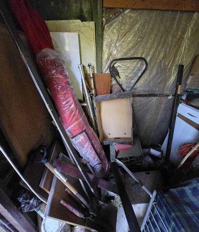 Storage area containing tools, poles, bags and equipment requiring shed and storage clearance.