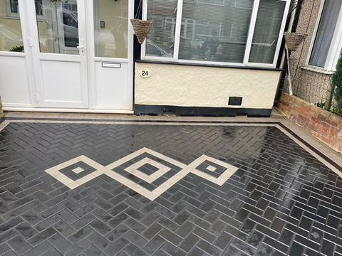 A bricked patio with a pattern