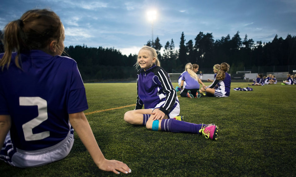Girls Relaxing on Soccer Field