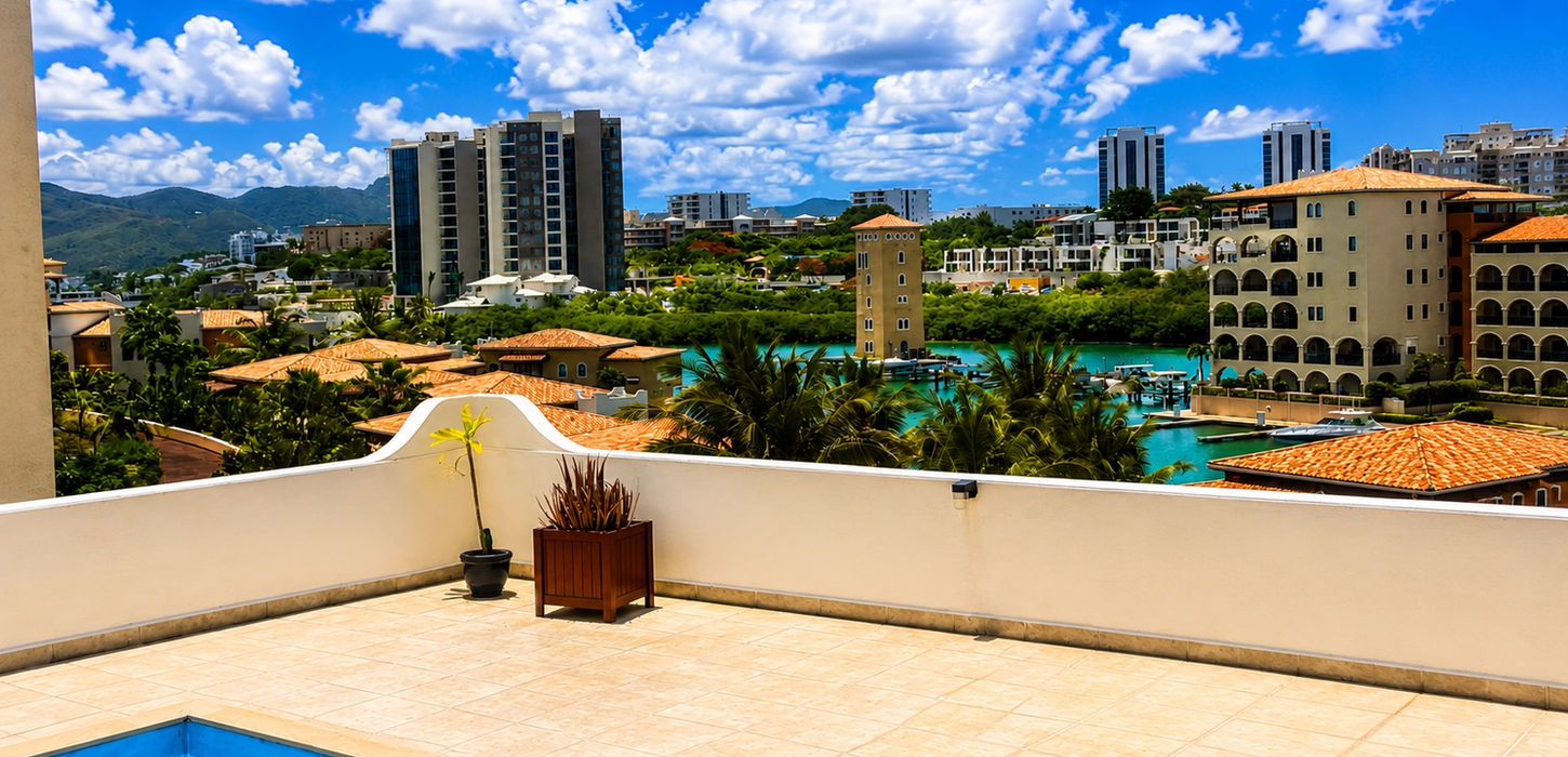 Covered terrace with lounge and dining area offering ocean views at a luxury penthouse in Cupecoy, St. Maarten.