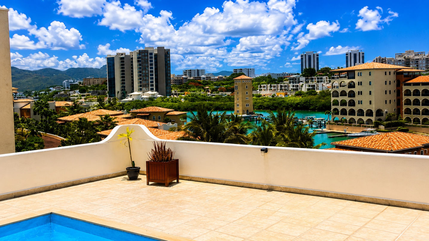 Covered terrace with lounge and dining area offering ocean views at a luxury penthouse in Cupecoy, St. Maarten.
