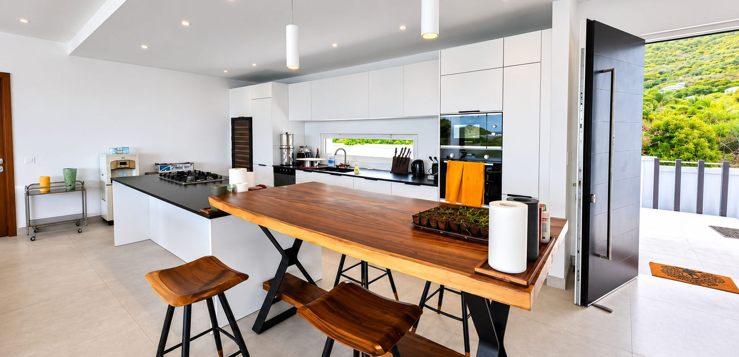Modern designer kitchen with large island, premium appliances and open-concept layout in luxury villa for sale in Guana Bay, St. Maarten.