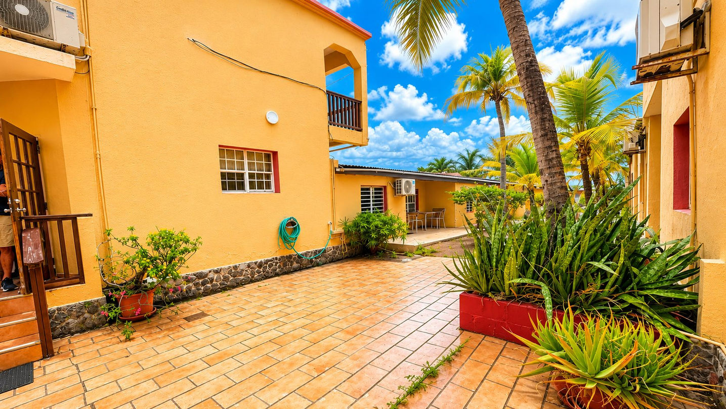 Spacious tiled courtyard surrounded by tropical landscaping at income-producing apartment complex for sale in Beacon Hill, St. Maarten.
