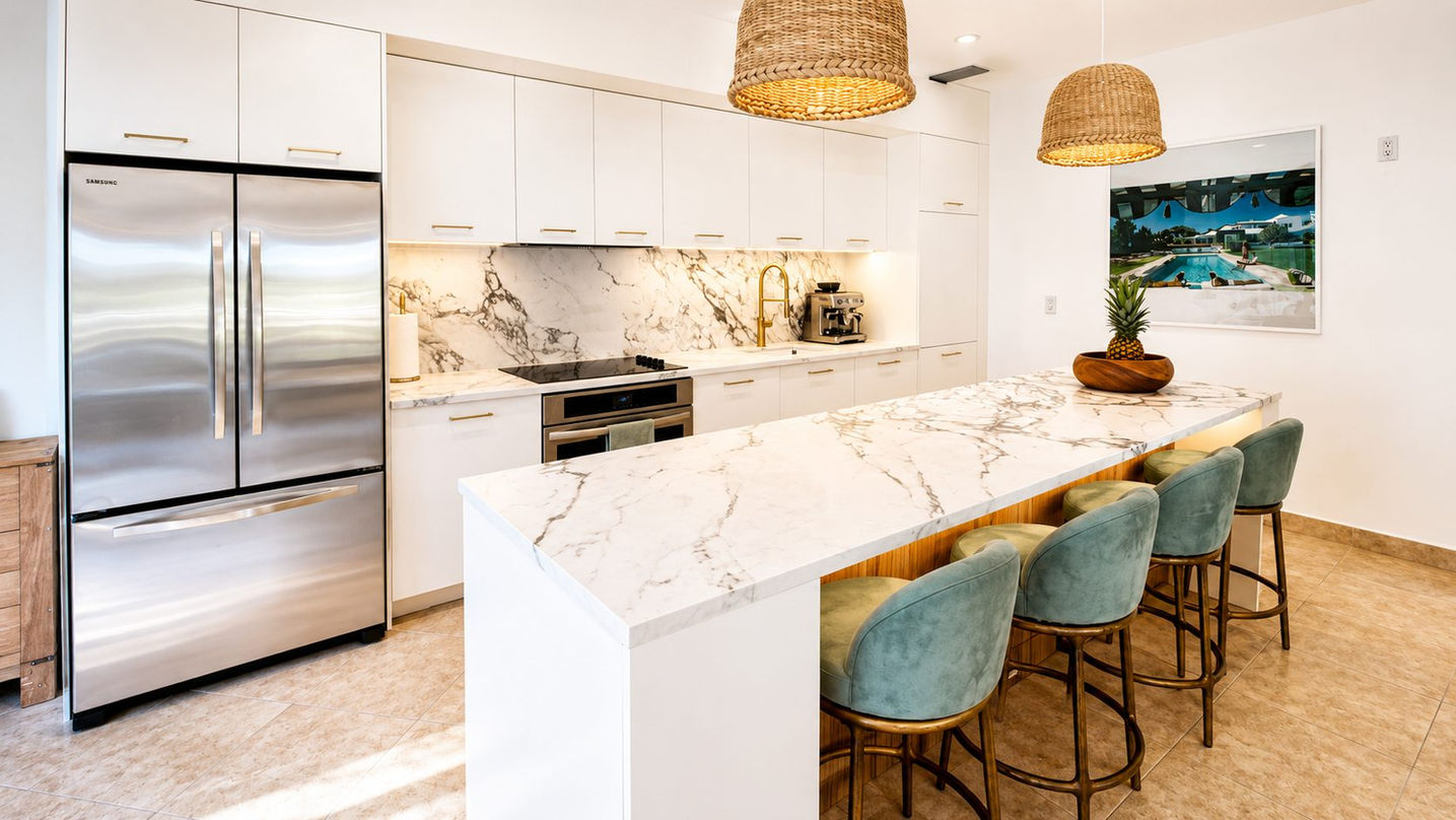 Modern luxury kitchen with marble waterfall island in Porto Cupecoy condo for sale in Sint Maarten