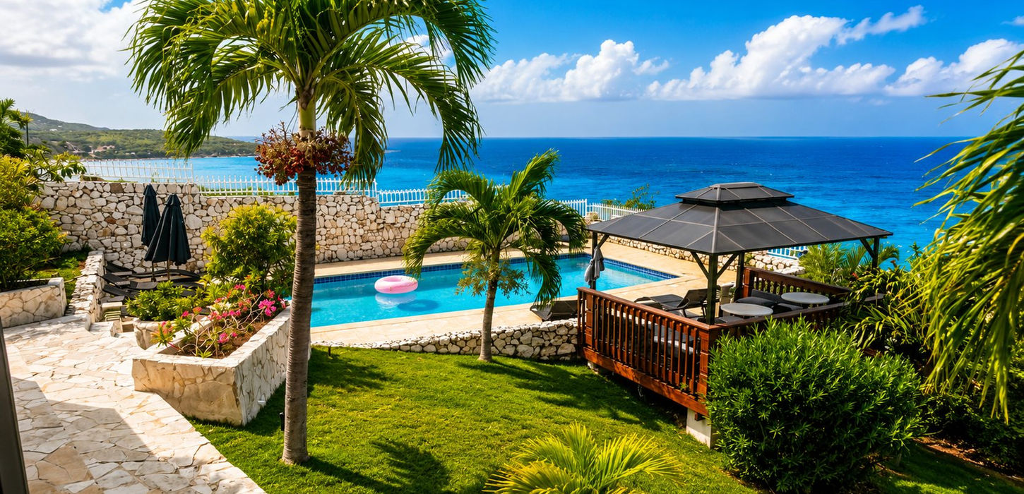 Luxury Caribbean villa exterior with large swimming pool, tropical gardens and ocean views in St. Maarten