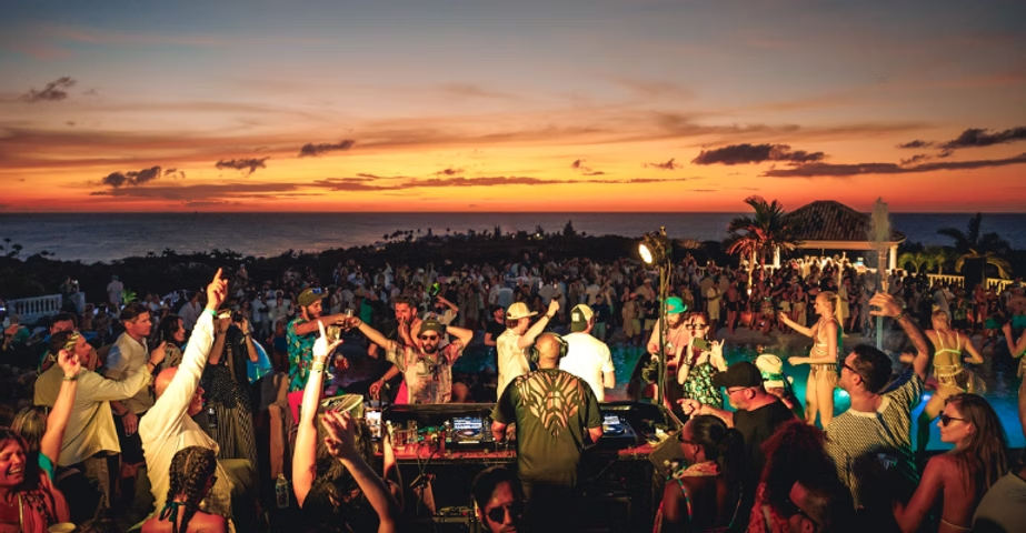 sxm festival in sint maarten with people dancing with a sunset view
