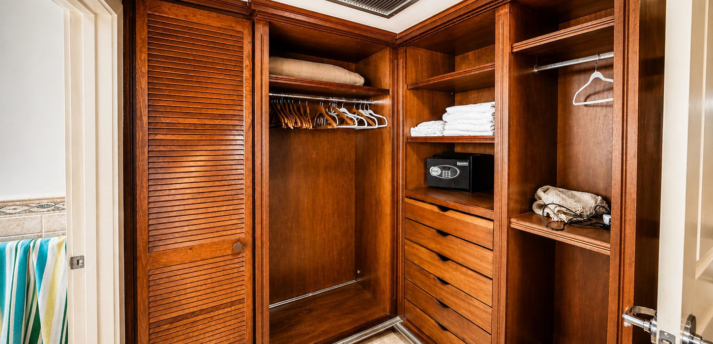 Custom walk-in closet with built-in cabinetry and storage in a luxury oceanfront condo in St. Maarten.
