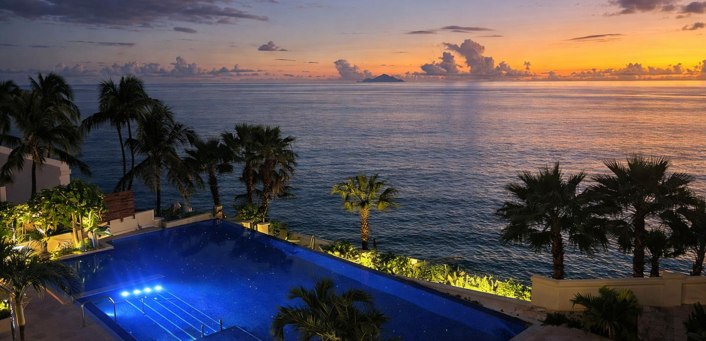 Luxury condo pool illuminated at night with city views, Sint Maarten real estate, upscale residence ambiance at the cliff residence cupecoy