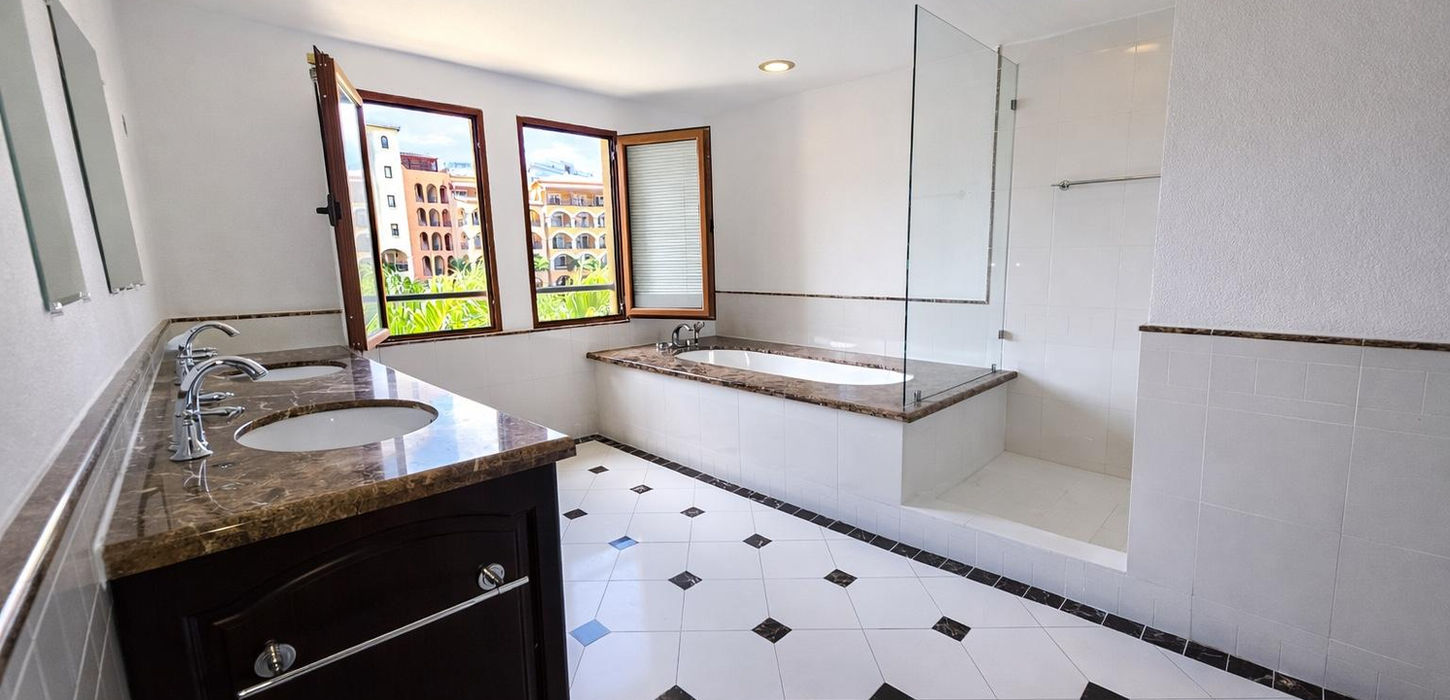 Modern bathroom with double vanity and walk-in shower in Sint Maarten condo for sale