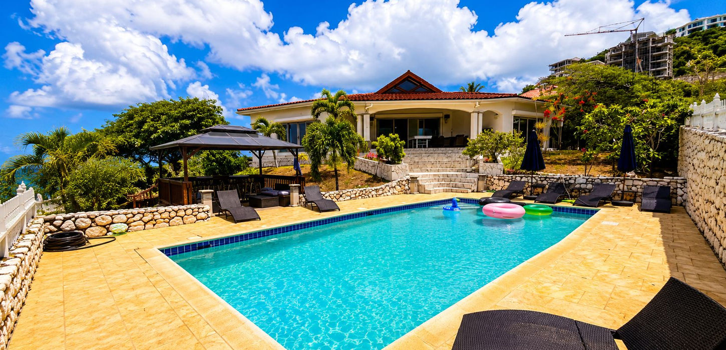 Luxury ocean-view swimming pool at Caribbean villa for sale in St. Maarten with sun deck and panoramic sea views