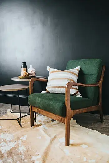 Een vintage stoel met een leuk kussen in een moderne woonkamer
