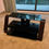 Thumbnail: Black Glass TV Unit with Curved Wooden Sides – Modern Design