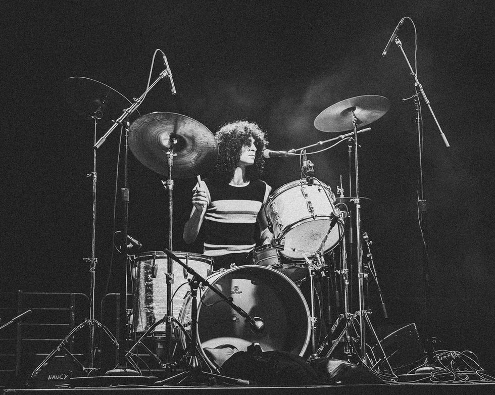 Black and white photo of a drummer performing.