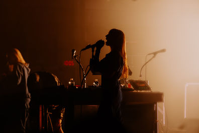 Silhouette of a singer performing on stage.