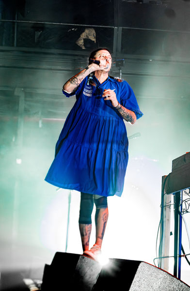 Person in blue dress performing on stage.