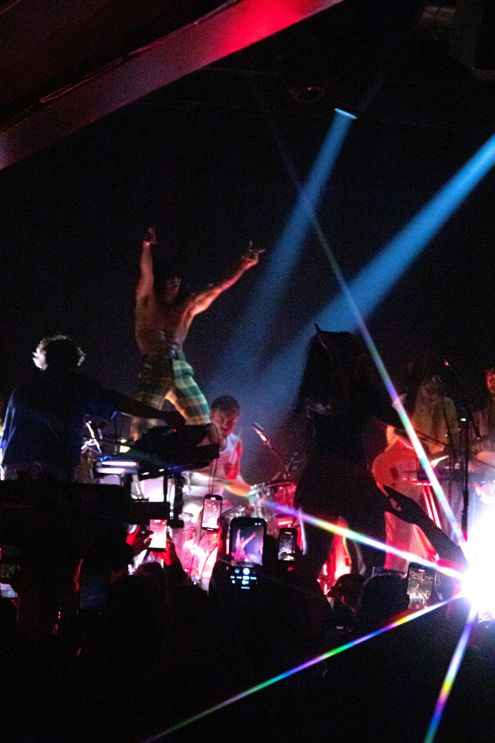 Energetic concert scene with colorful stage lighting.