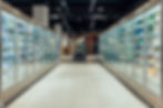 Empty supermarket aisle with freezers showcases with different products.jpg