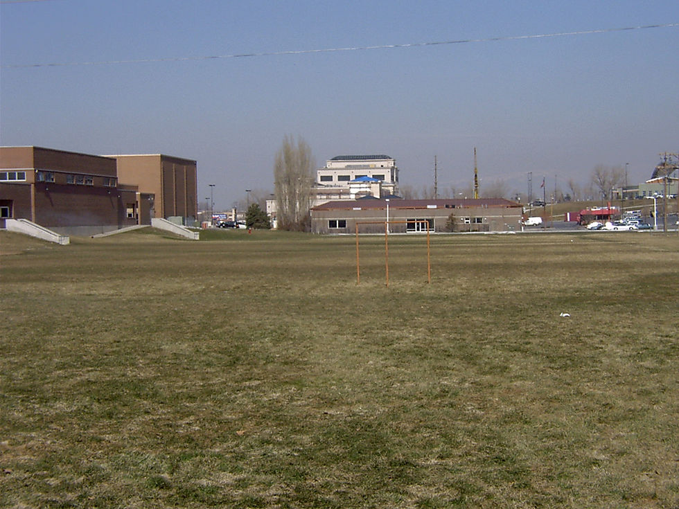 Hillcrest Junior High at left, with Murray Library and the Take Five Drive-In beyond a long, grassy, athletic field.