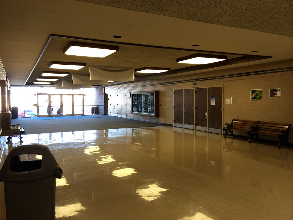Hillcrest Junior High entry hall looking toward the glass front doors, with trophy cases and benches