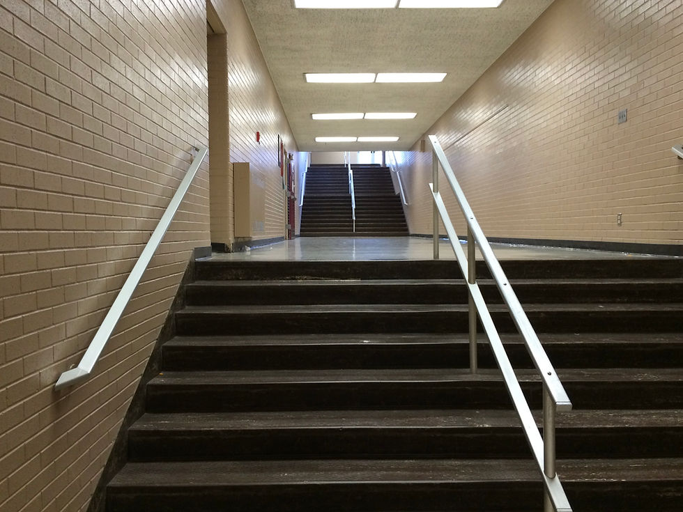 Stairs to a landing leading to more steps that disappear into the ceiling above.