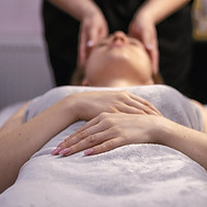 a woman getting a facial massage at a sp