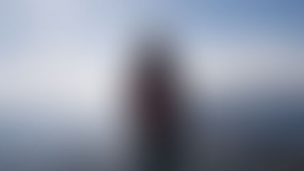 Person standing alone in the mountains during a sabbatical, reflecting on slowing down and personal change