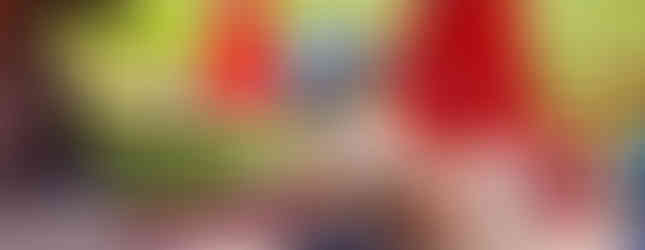 Café terrace with red umbrellas and mountain view — valley stop.