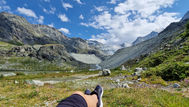 resting in nature with legs stretched mountain view calm moment without productivity pressure