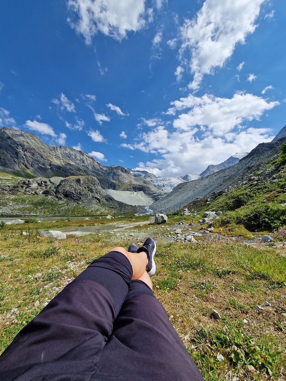 resting in nature with legs stretched mountain view calm moment without productivity pressure