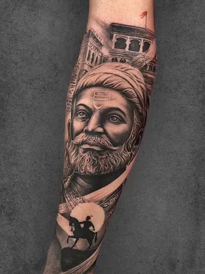 Realistic Double Exposure Shivaji Maharaj tattoo on the forearm of a male, with historical structures and a horseback silhouette.