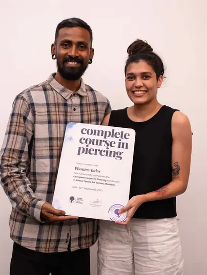 Mentor Sachin providing a graduation certificate to the pro-piercing course student