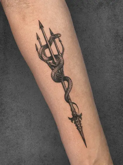 This trident entwined with a serpent represents power and resilience. The bold lines and detailed scales emphasize the strength of both symbols, creating a piece that commands attention and respect