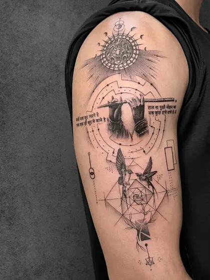 A geometric tattoo featuring a divine figure, birds, and celestial designs, in fine line art, placed on the upper arm