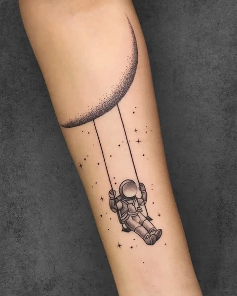 small astraunaut and moon tattoo