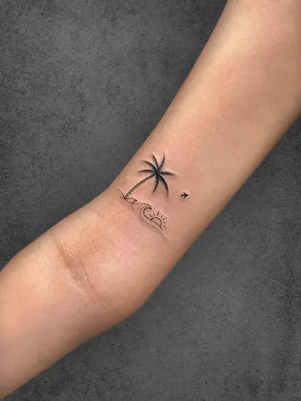 A minimalist tattoo of a palm tree, ocean wave, and sunrise with a small bird, symbolizing relaxation and travel, placed on the forearm