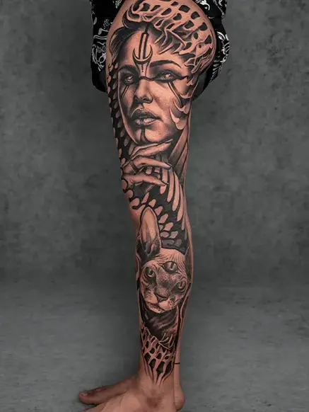 Goddess and Cat Full-Leg Tattoo: Divine feminine portrait with a cat and bold details. Full-leg sleeve, likely female.