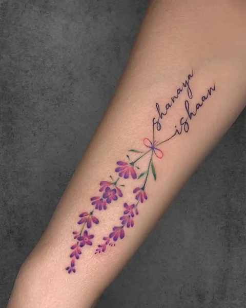 minimal lily flower with lettering tattoo