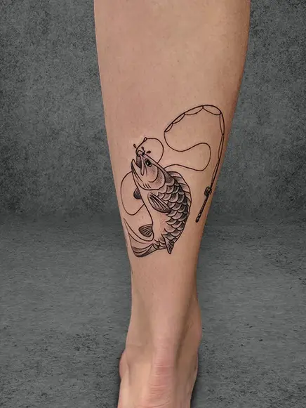 Line-art tattoo of a fish and fishing rod wrapping around male calf, simplistic black ink.