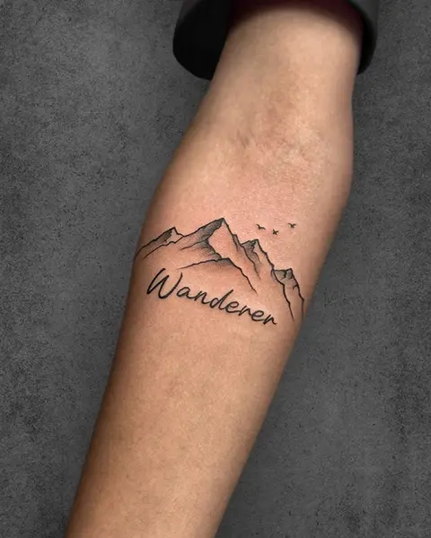 A minimalistic tattoo of a mountain range with the word 'Wanderer' beneath it, and small birds flying above, done in fine line art, placed on the forearm